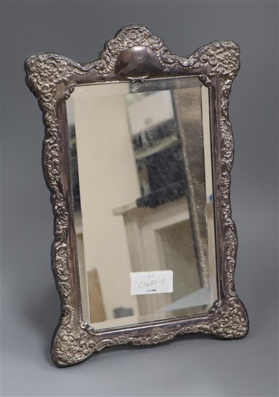 A modern repousse silver shaped rectangular photograph frame, Carrs of Sheffield Ltd, Sheffield, 1992, approx. 38cm.
